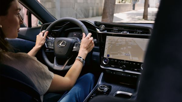 A person driving a Lexus RX