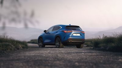 A Lexus NX driving in a rural location