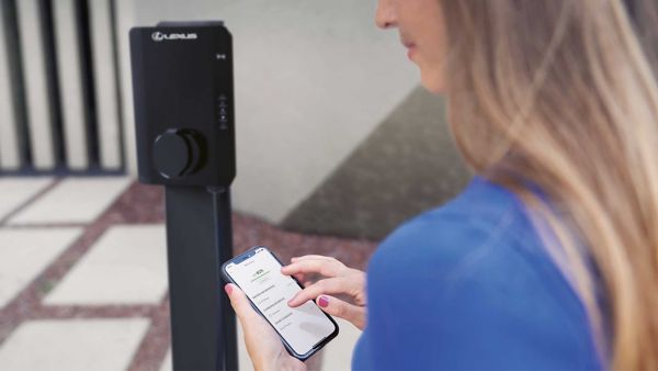 A person using the Lexus Link+ app stood by a charger