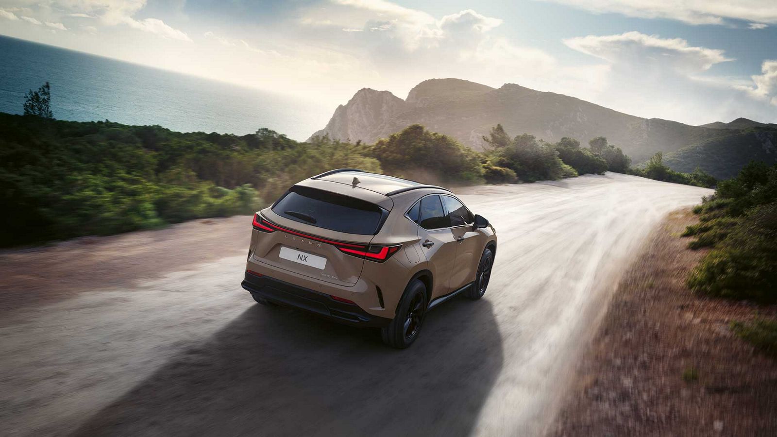 Rear view of a Lexus NX driving on a coastal road