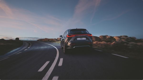 A Lexus NX driving along a coastal road