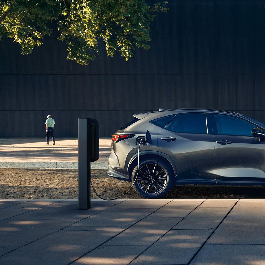 A parked Lexus NX 450h+ charging