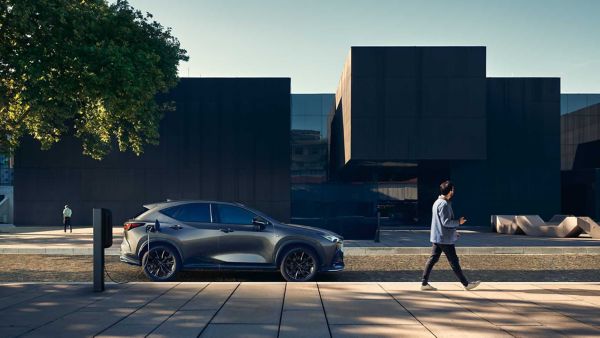 A parked Lexus NX charging on a street