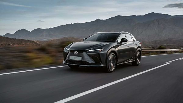 Lexus RZ driving on a hillside road