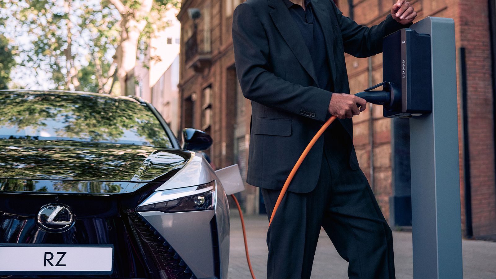 A person charging a Lexus RZ
