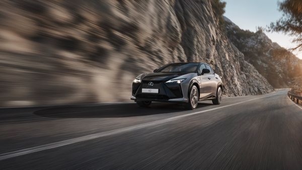 A lexus RZ 300e driving on a mountainous road