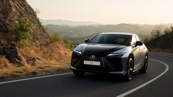 An all-new Lexus RZ driving on a hillside road
