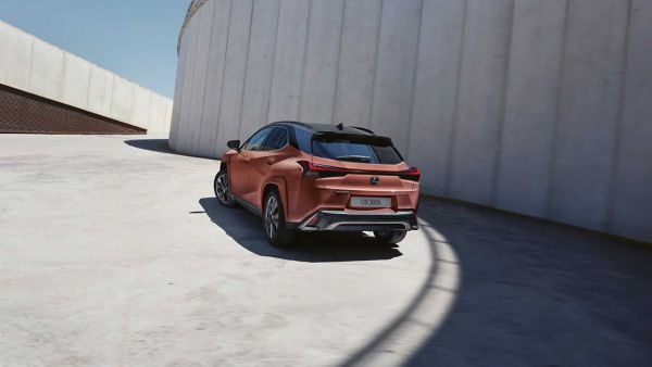 A Lexus UX driving round a bend