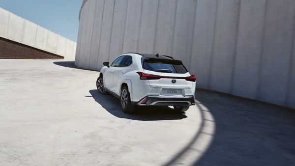 A Lexus UX driving round a bend