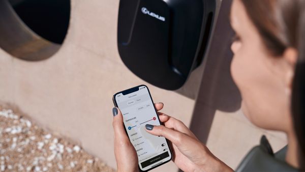 A person using their phone to control the climate of their Lexus