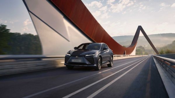 A Lexus RZ driving over a bridge