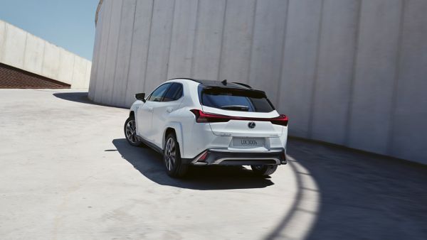 A Lexus UX driving round a bend