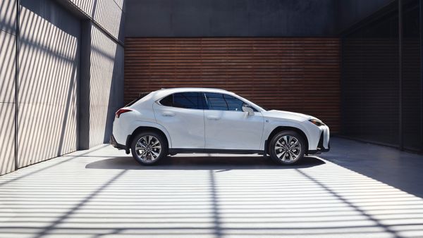 A Lexus UX parked next to a wall