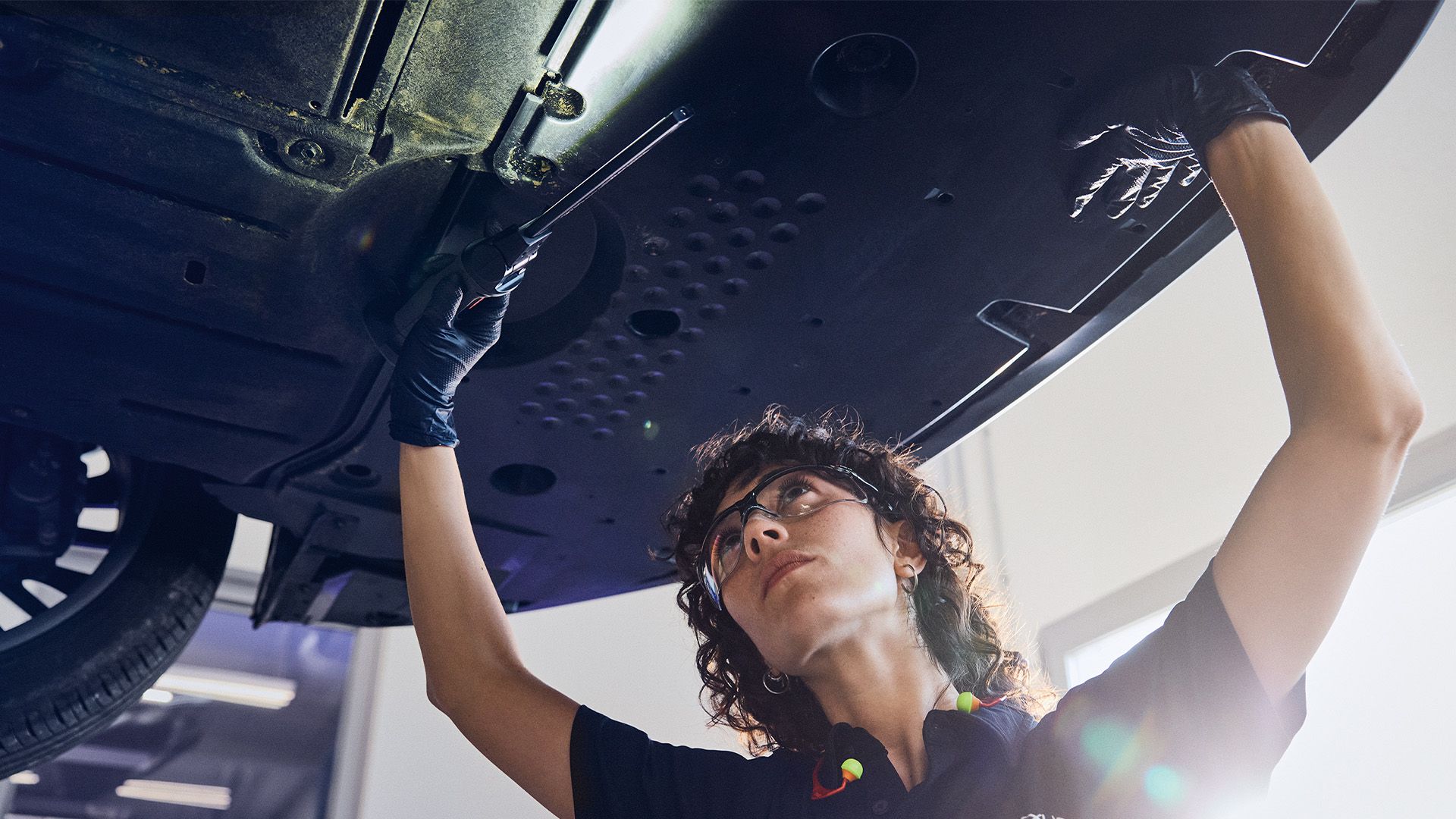 A Lexus mechanic inspecting a vehicle