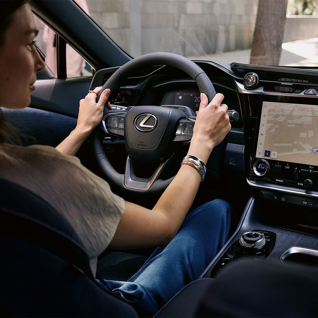 A person driving a Lexus RZ