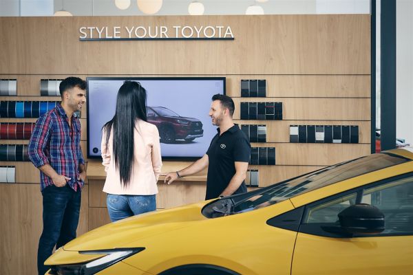 Toyota sales person talking with clients