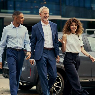Work colleagues walk past a Toyota  