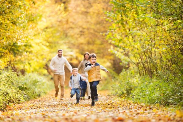 Family running through woodland