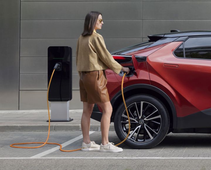 Kobieta ładuje Toyotę