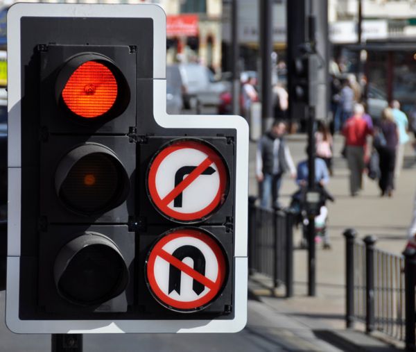 Traffic light accompanied by banned turns signs