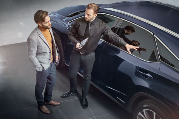 A Lexus employee handing over some Lexus keys