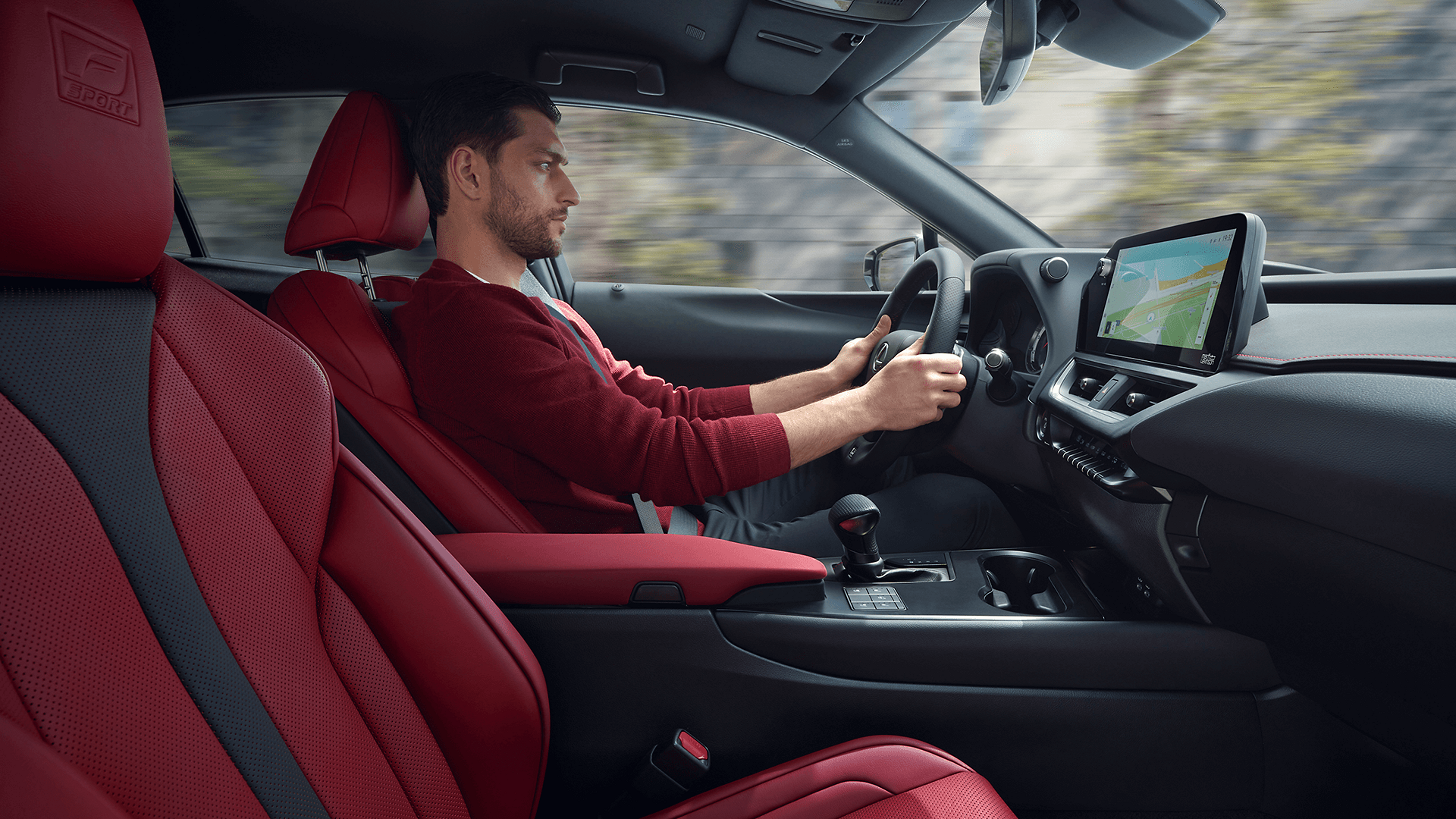 A person driving a Lexus UX