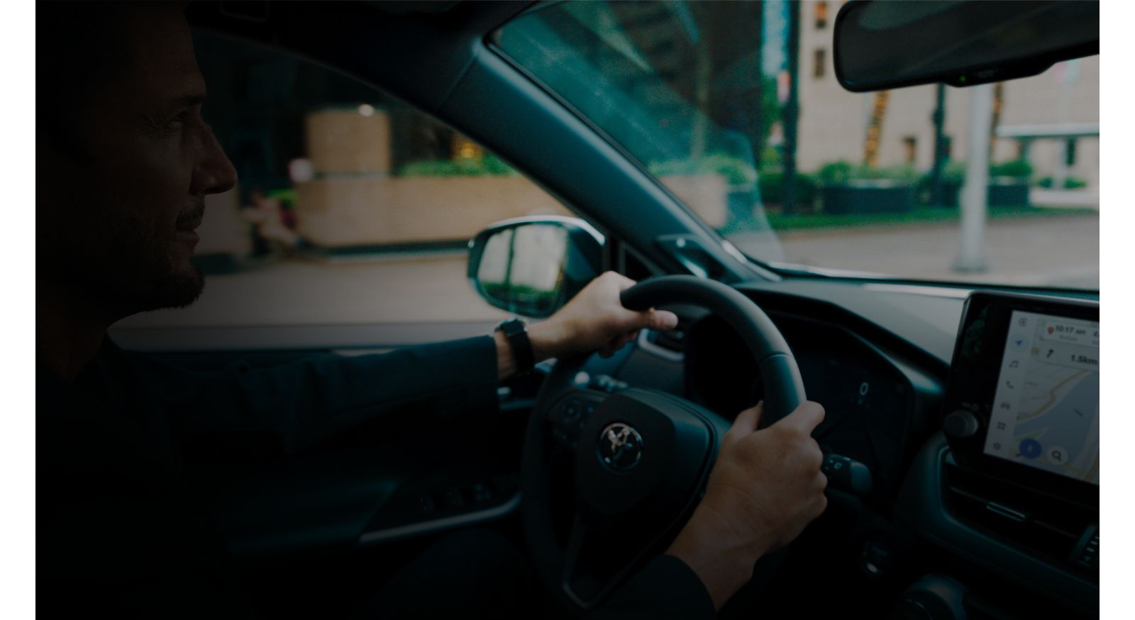 An owner at the wheel of their RAV4 