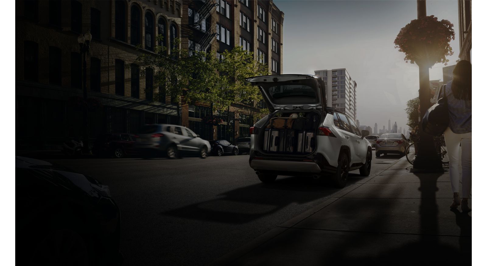 A RAV4 on the street, packed with luggage ahead of a trip