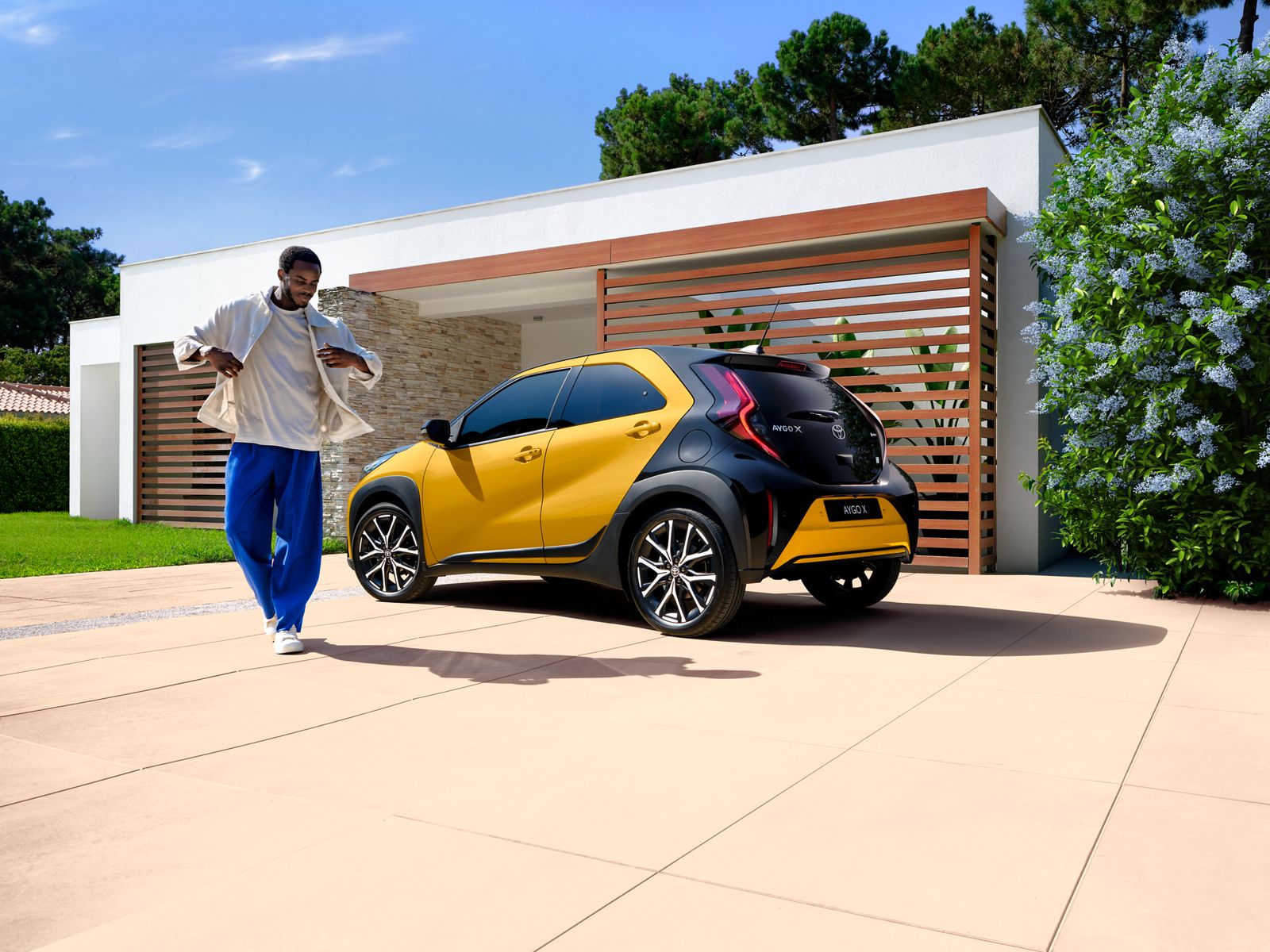 Aygo X GR SPORT parked outside a house