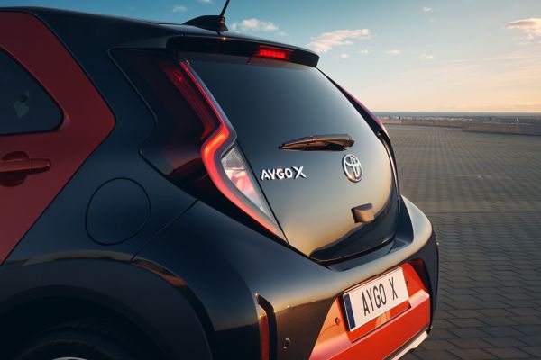 Detail of Aygo X on a scenic background.