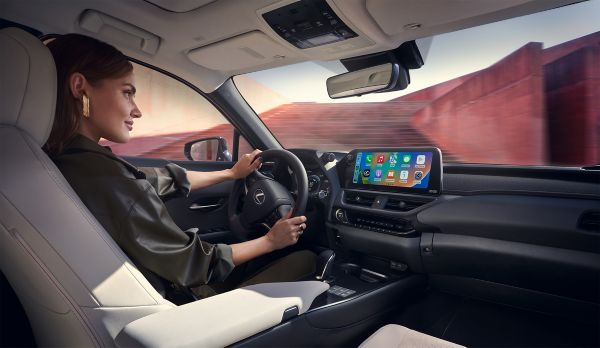 An interior shot of a woman driving a Lexus
