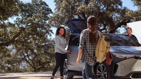 Family standing around Toyota bZ4X
