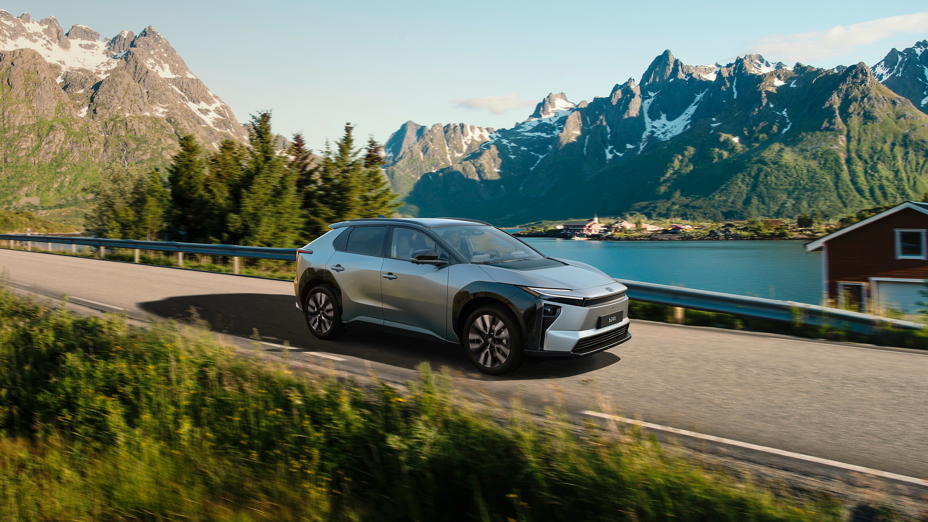 A Toyota bZ4X drives through a beautiful landscape