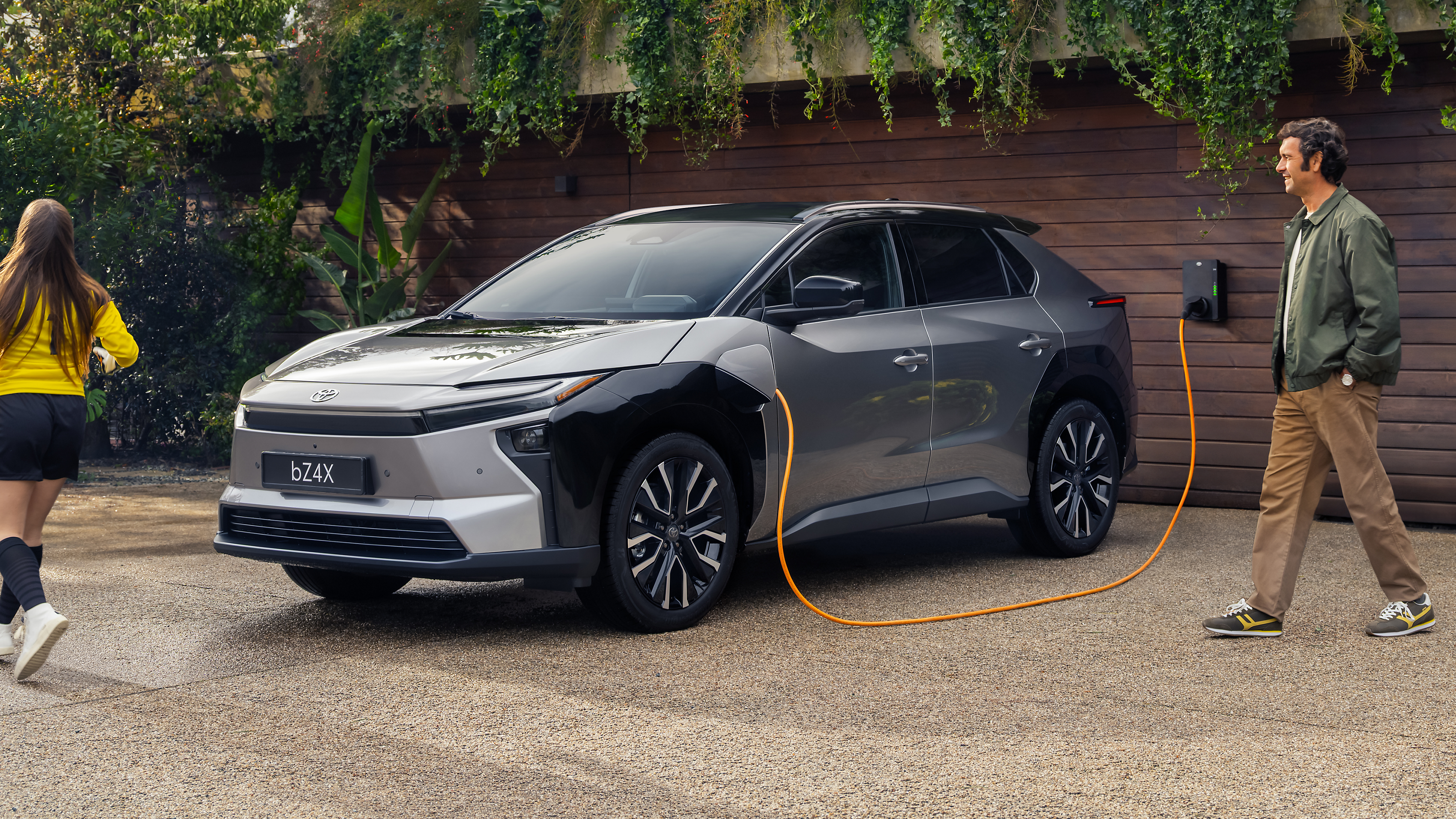 A family with their Toyota bZ4X charging at home