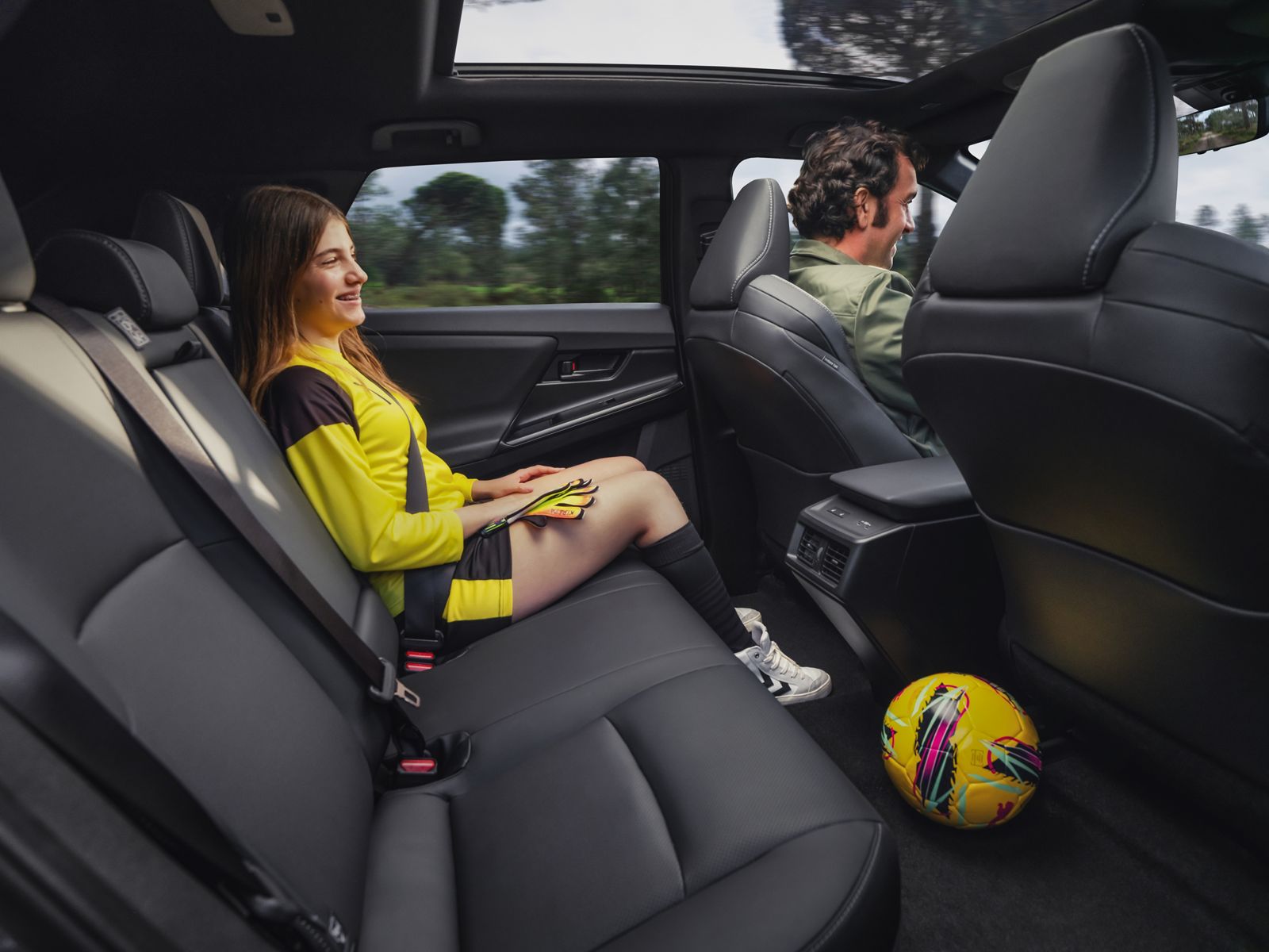 A bZ4X passenger enjoying the roominess and comfort of the luxurious interior