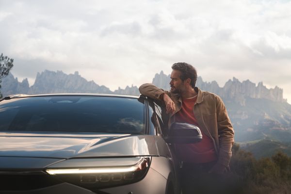 Man leaning on Toyota roof