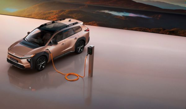bZ4X Touring charging in a studio in front of giant LED screen showing mountain range