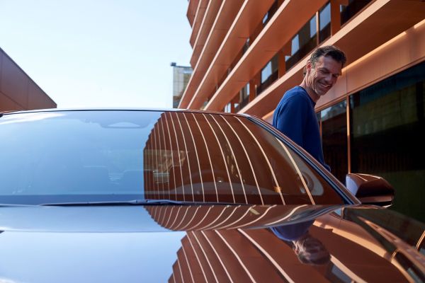 Man smiling while exiting Toyota Camry