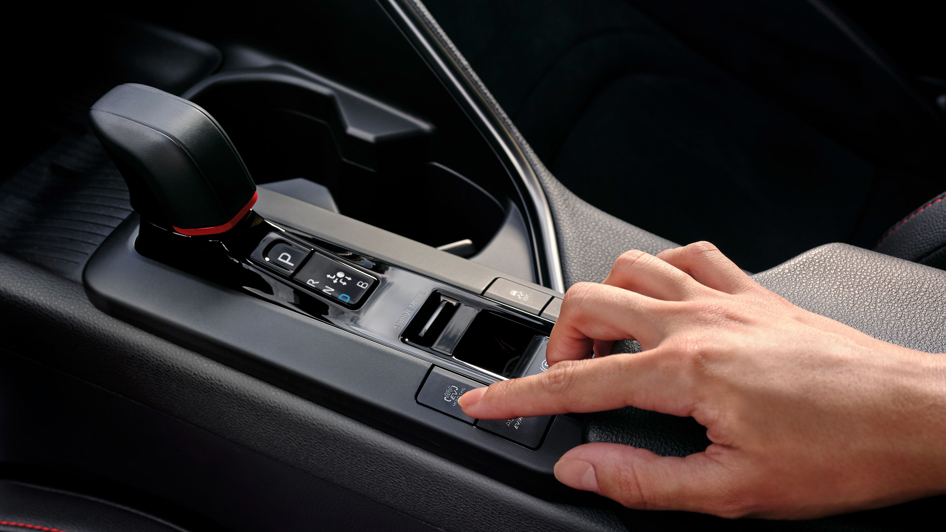 Toyota C-HR driver about to press the EV mode button