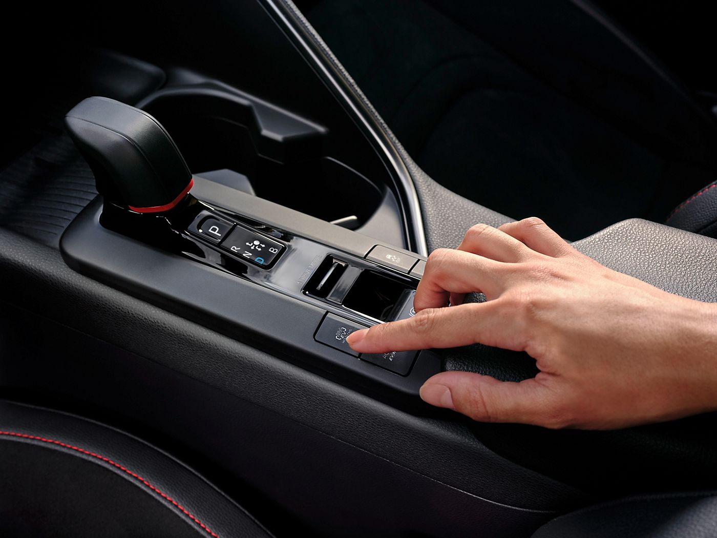Toyota C-HR driver about to press the EV mode button