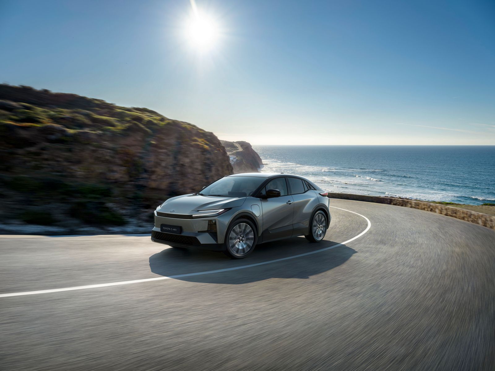 TOYOTA C-HR+ driving on a coastal road
