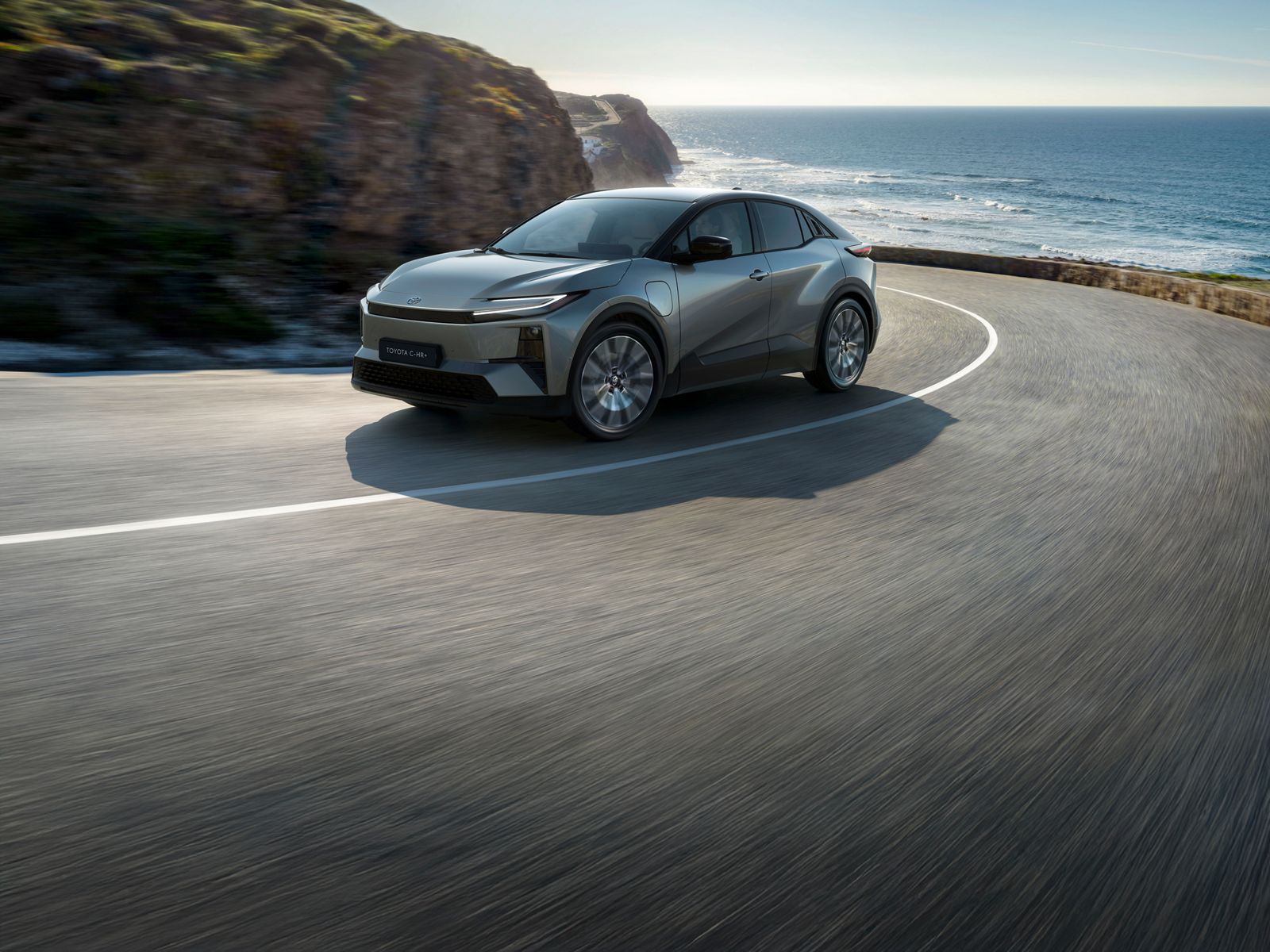 Toyota C-HR+ driving on a coastal road