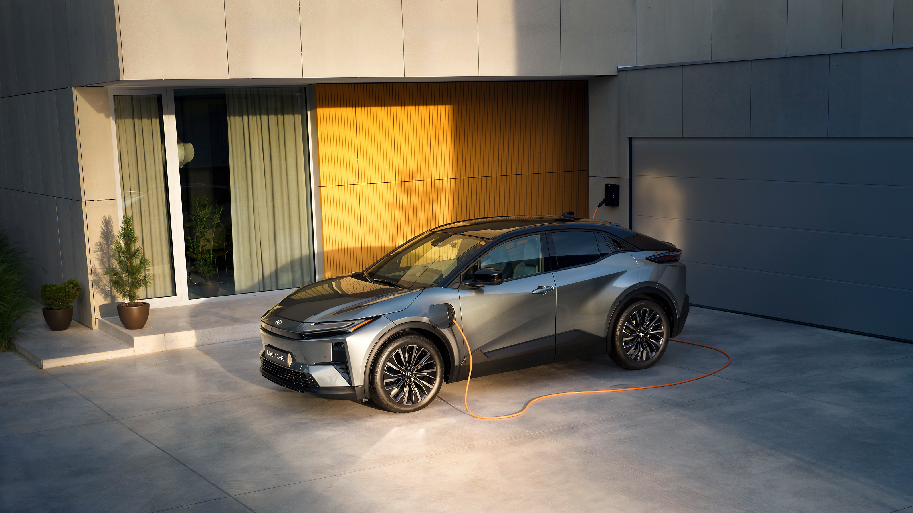 An owner charges a Toyota C-HR Plug-in Hybrid at home 