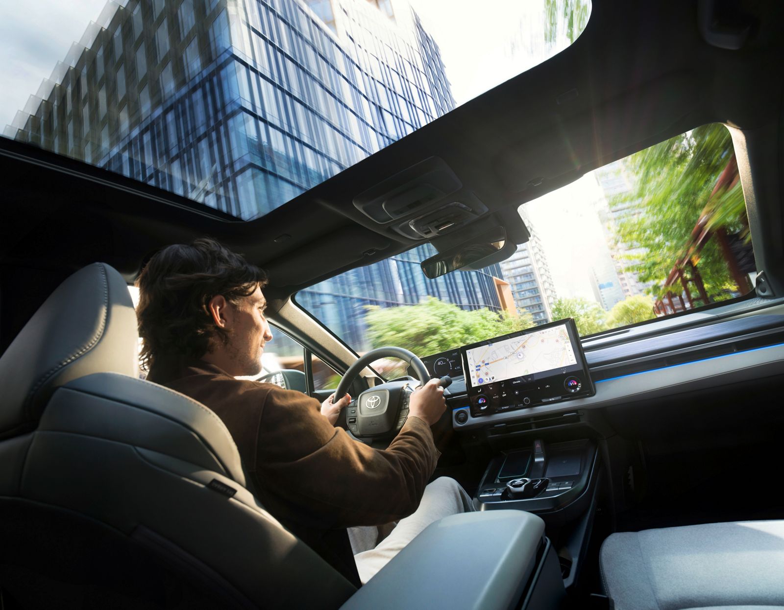 Toyota C-HR+ driver enjoying driving in the city