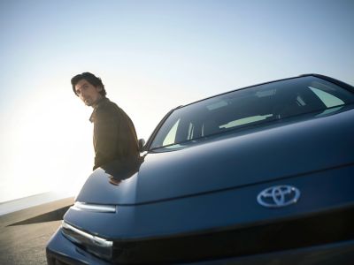 A Toyota owner relaxes with their car