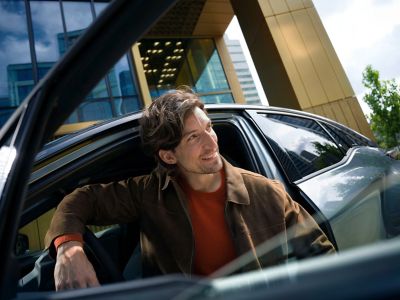 A Toyota owner with their vehicle in the city