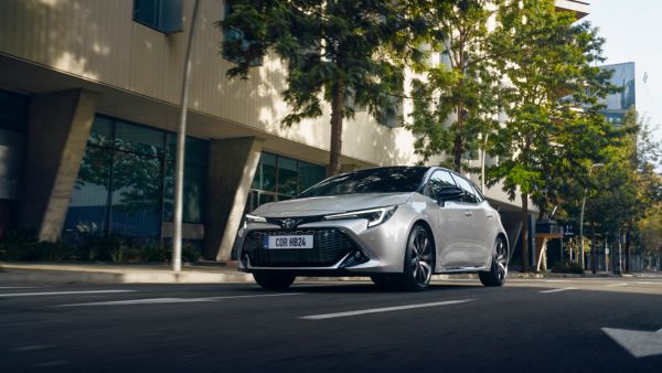 Toyota Corolla Hatchback driving down the road