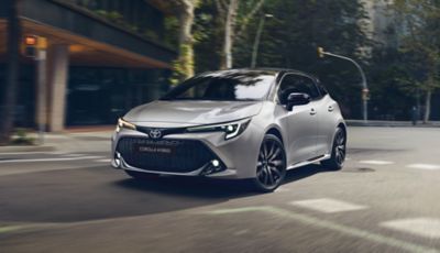 Toyota Corolla driving on city road