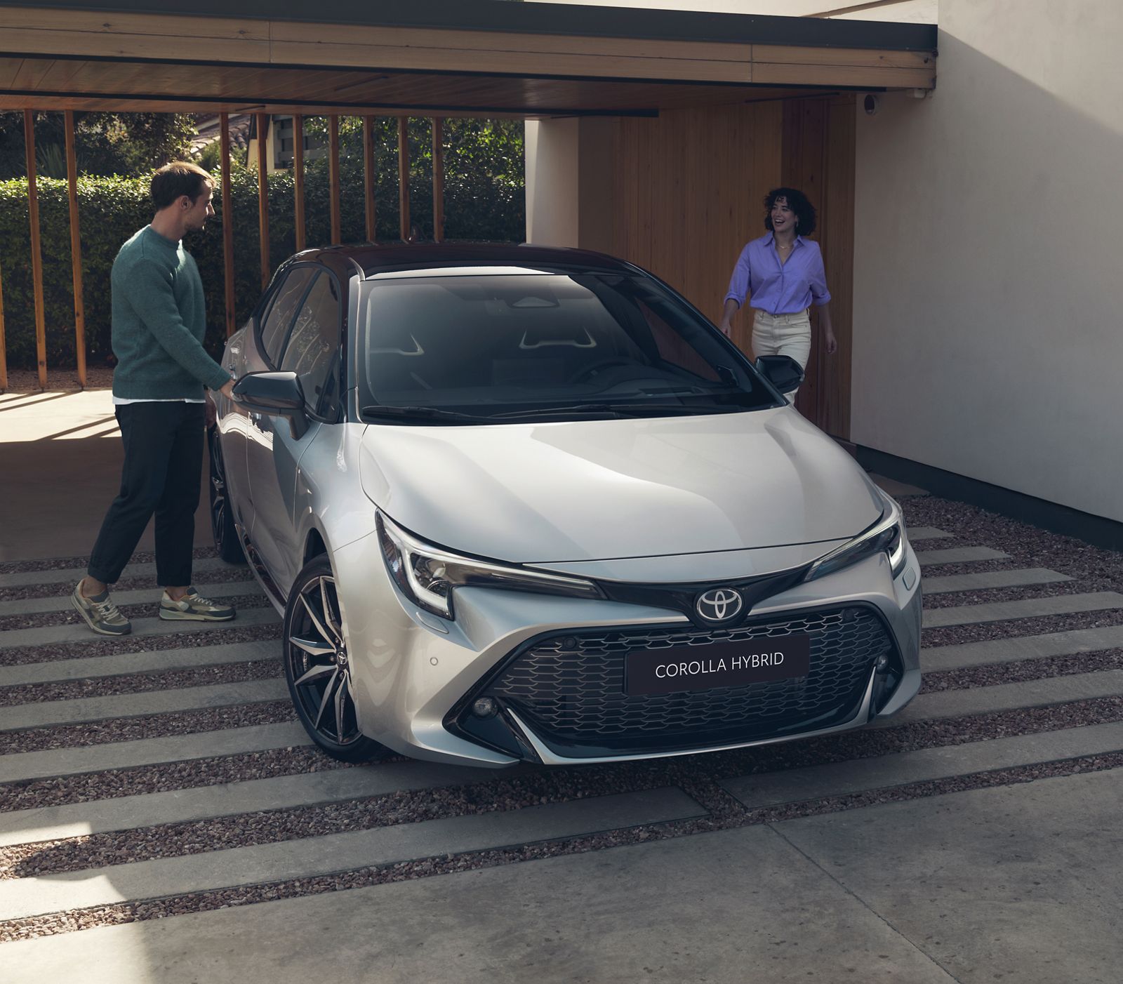 An owner opens one of their Toyota Corolla Hatchback’s rear doors