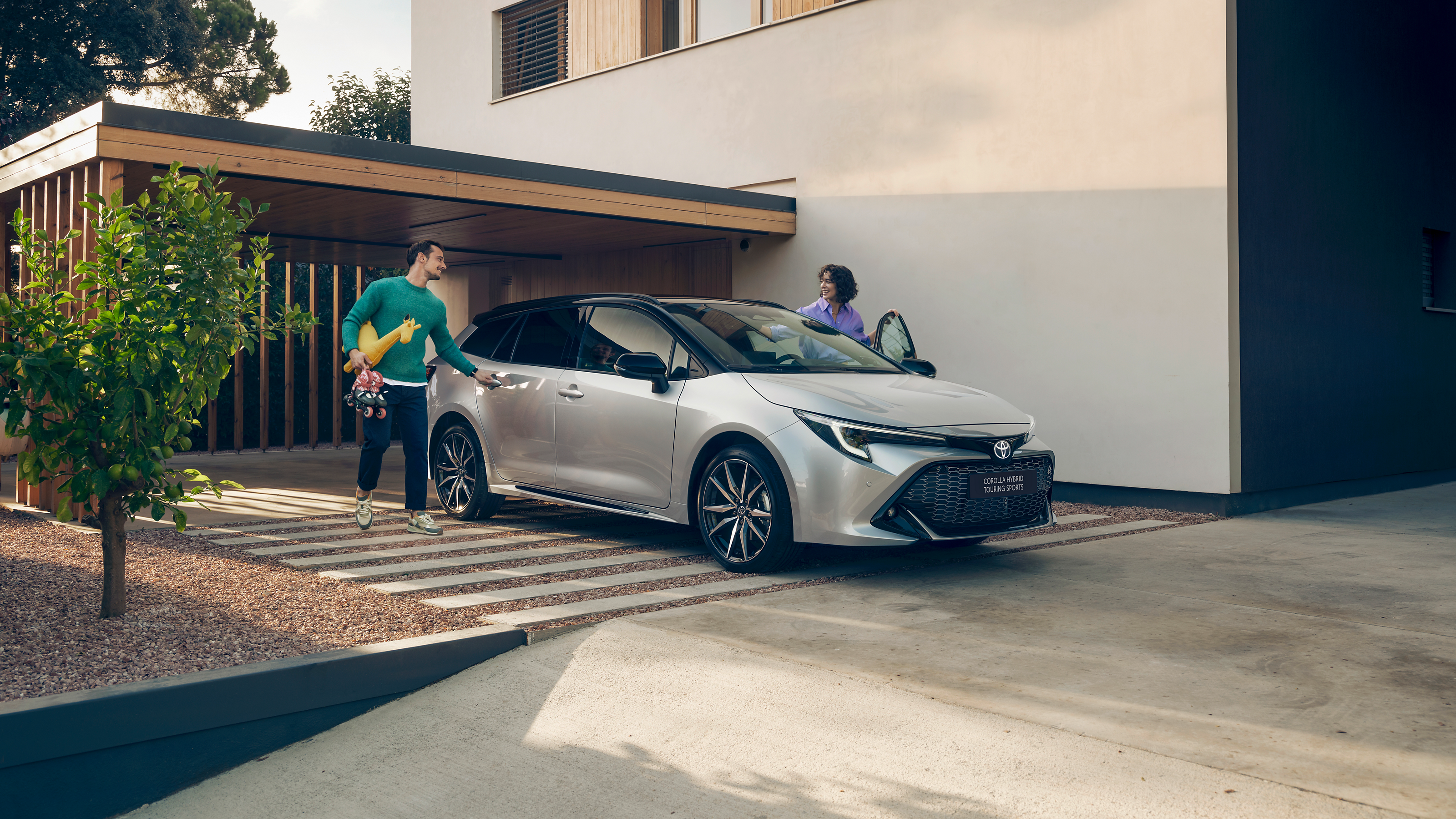 A family with their Toyota Corolla Touring Sports